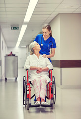 nurse with senior woman in wheelchair at hospital