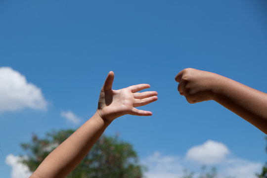 roshambo sign with a bright sky background, Rock paper scissors  Image ID:425734387