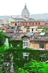 Obraz premium The building is overgrown with vines. Behind the house you can see the St. Peter's Basilica.