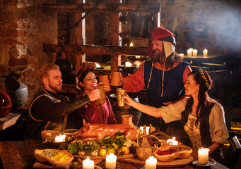 Medieval people eat and drink in ancient castle kitchen interior - obrazy, fototapety, plakaty