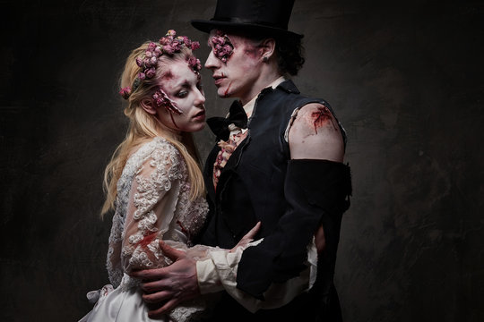 Dressed in wedding clothes romantic zombie couple