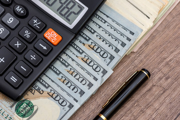 pen, money and calculator on desk