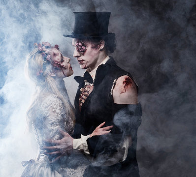 Dressed in wedding clothes romantic zombie couple