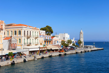 Obraz premium Symi island - Colorful houses and small boats at the heart of the village