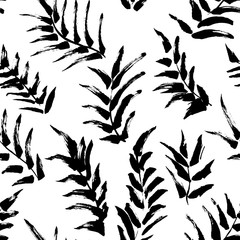 Ink seamless pattern with palm leaves in black and white colors. Artistic background with abstract plants. 