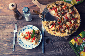 Greek tart with feta cheese and olives. Wooden rustic table