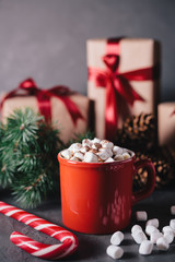 Hot chocolate or cocoa with marshmallows on gray background. Christmas presents. Holiday concept.
