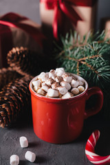 Hot chocolate or cocoa with marshmallows on gray background. Christmas presents. Holiday concept.