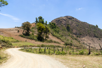 Mountain valley with volcano and road. Guatemala.