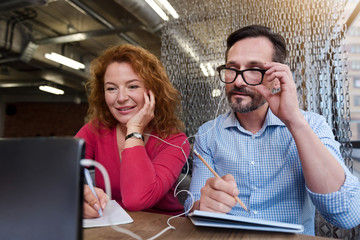 Middle-aged couple working with tablet