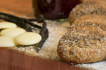 cookies and biscuits presented on a wooden board with ingredients next to it