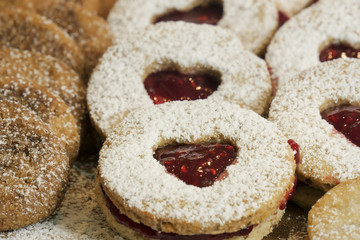 cookies and biscuits presented on a wooden board with ingredients next to it