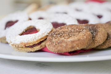 collection of heart shaped biscuits or cookies served at home on a white plate