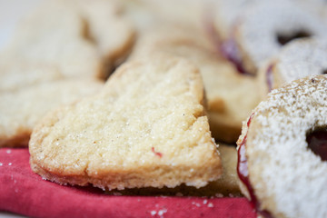 collection of heart shaped biscuits or cookies served at home on a white plate