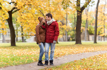 happy young couple walking in autumn park