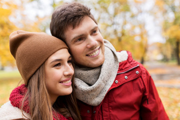Fototapeta premium happy young couple walking in autumn park