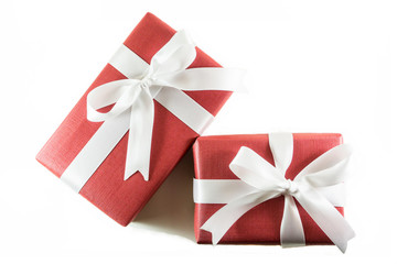 Red gift box with white ribbon bow, isolated on white background