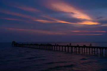  Filed wooden bridge into the sea at sunset in Thailand