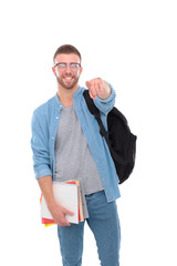 Fototapeta premium Young male student with a school bag holding books and pointing you isolated on white background