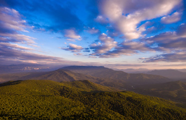  Mountain landscape. Forest and cloudy sky.