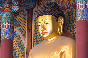 A big golden Buddha statue inside an ancient temple