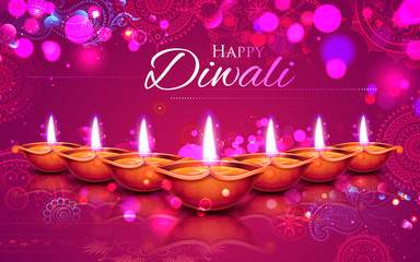 Burning diya on Happy Diwali Holiday background for light festival of India