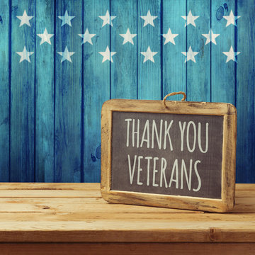 Veterans day background with chalkboard on wooden table