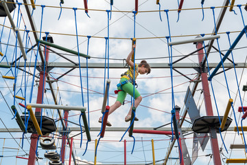 girl in a special gear on a obstacle course passes obstacles