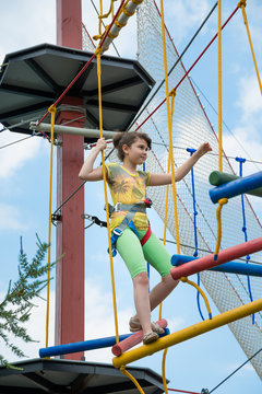 girl in a special gear on a obstacle course passes obstacles