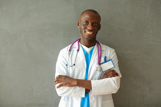 Doctor With Arms Folded In Modern Office