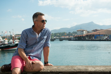 Naklejka na ściany i meble Handsome man. Outdoor male portrait. Middle-aged man resting at