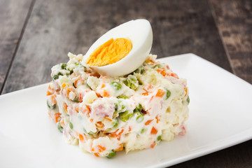 Russian salad on rustic wooden table

