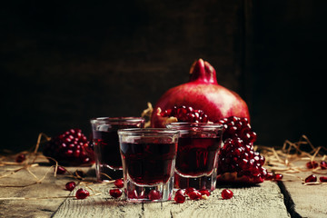 Homemade pomegranate liqueur, still life in rustic style, vintag
