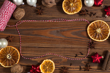 Christmas toys, oranges, nuts on a wooden background concept Chr