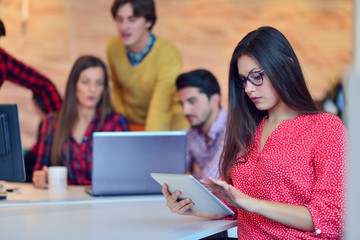 Young professionals work in modern office.Project manager team discussing new idea.Business crew working with startup.Desktop computer table,showing presentation, monitor.Blurred,film effect.