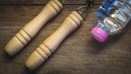 jump rope and water bottle on wooden block