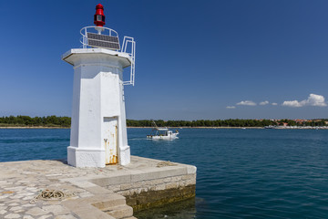 Fishing boat next to the lighthouse © Mariusz Niedzwiedzki
