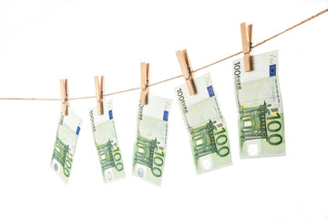 100 Euro banknotes hanging on clothesline on white background.
