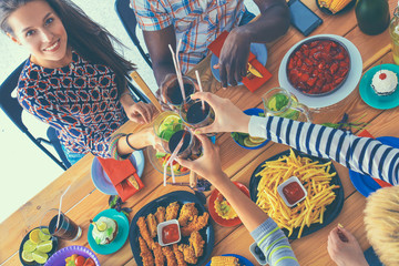 People with drinks while sitting at the dining table