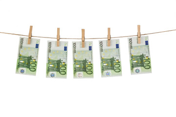100 Euro banknotes hanging on clothesline on white background.