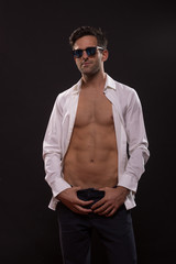 confident young man posing unbuttoned shirt