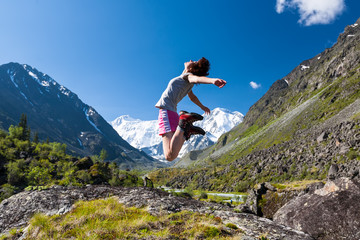 Woman jumps to the sky high in Altai mountains