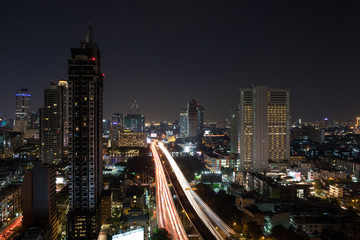 Night cityscape of Bangkok, Thailand capital. View to the illuminated buildings and busy motorway