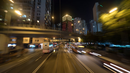Night Hong Kong view with high-rise buildings, road intersection and transport driving on the...