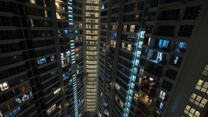 Lights in the windows of high-rise apartment block at night. Kuala Lumpur, Malaysia