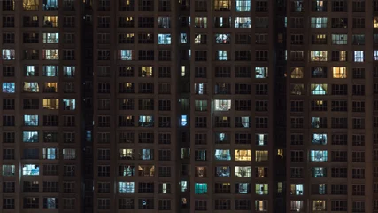 Fotobehang Lights in the windows of multistorey block of flats at night. Kuala Lumpur, Malaysia © danr13