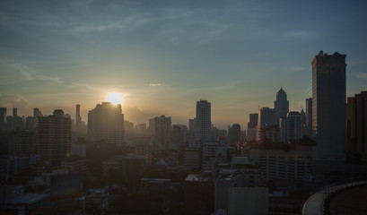 Fototapeta premium Cityscape with high-rise buildings at sunset. Bangkok in the light of evening sun, Thailand
