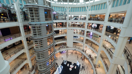 View of shopping mall interior. Multistorey trade centre with customers