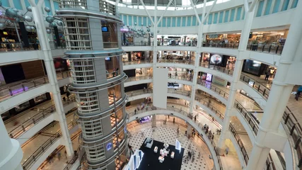 Fotobehang View of shopping mall interior. Multistorey trade centre with customers © danr13