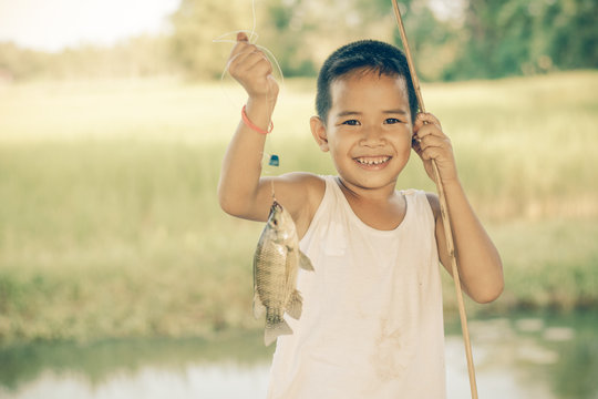 Little Boy Catching a Fish. Kids Fishing. Stock Photo